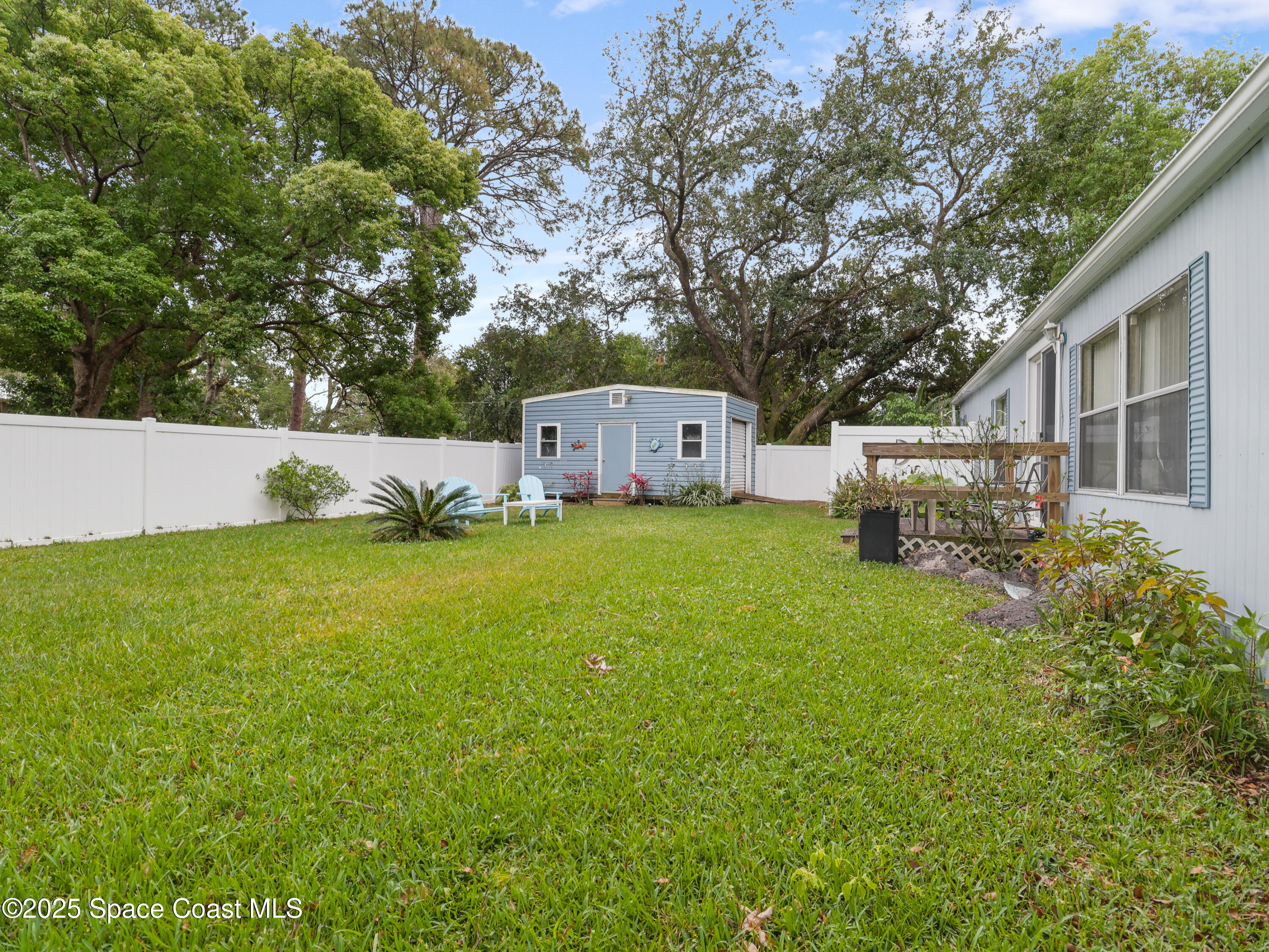 585 Canaveral Groves Boulevard Cocoa, FL 32926 - Photo 31 of 49 a view of house with backyard and trees