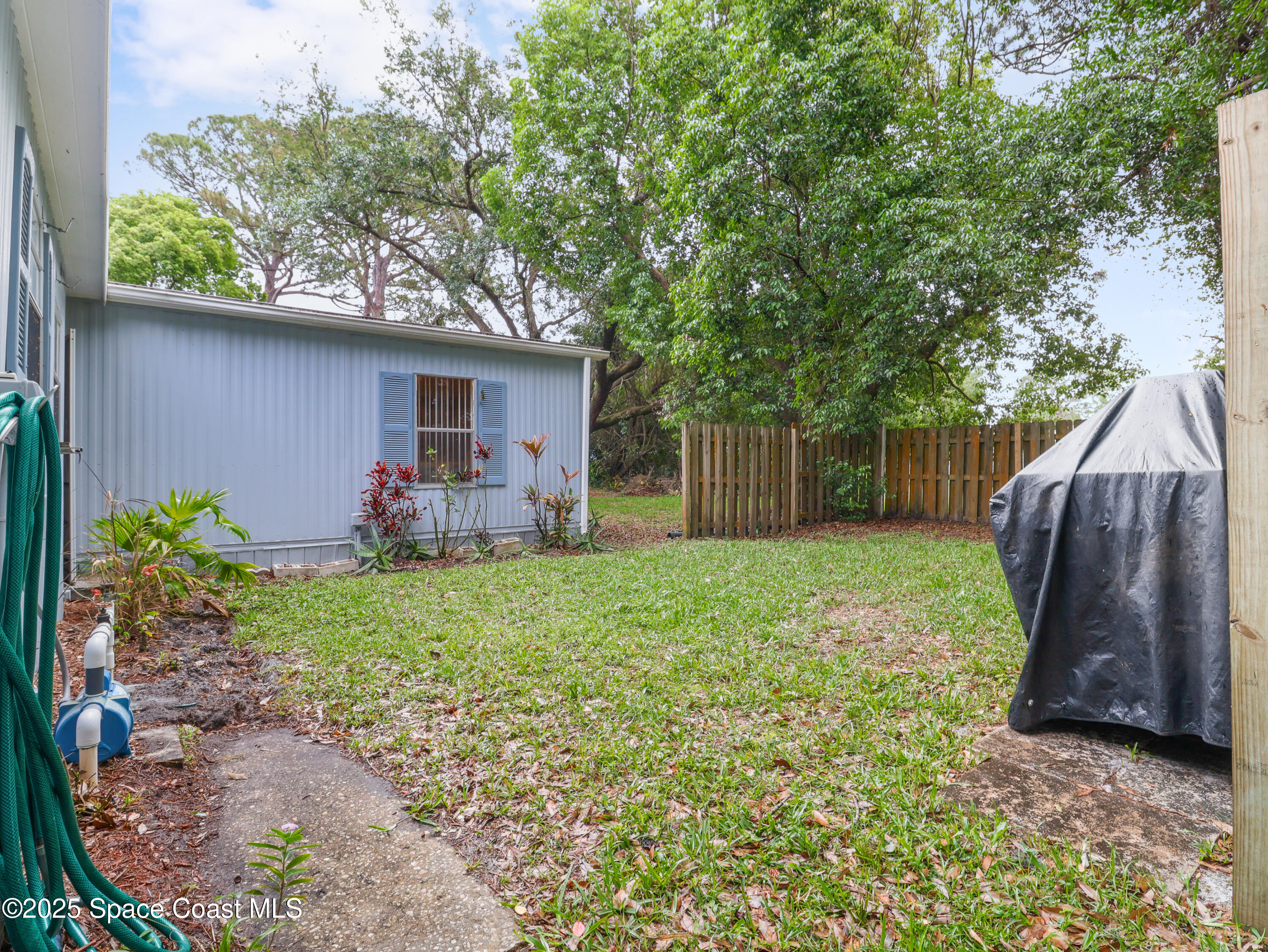 585 Canaveral Groves Boulevard Cocoa, FL 32926 - Photo 37 of 49 a view of a house with backyard and a tree