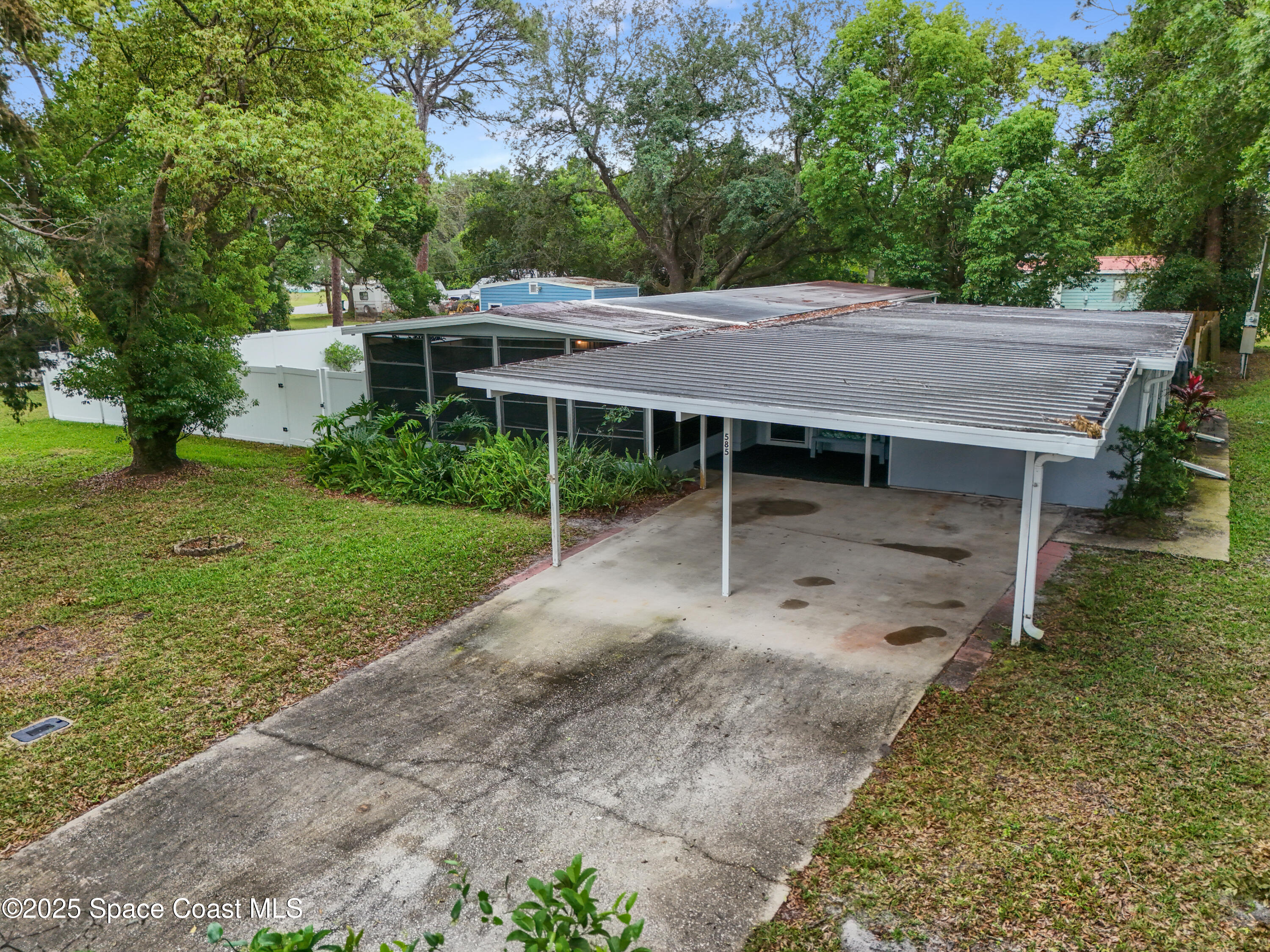 585 Canaveral Groves Boulevard Cocoa, FL 32926 - Photo 46 of 49 a view of a wooden house with a yard