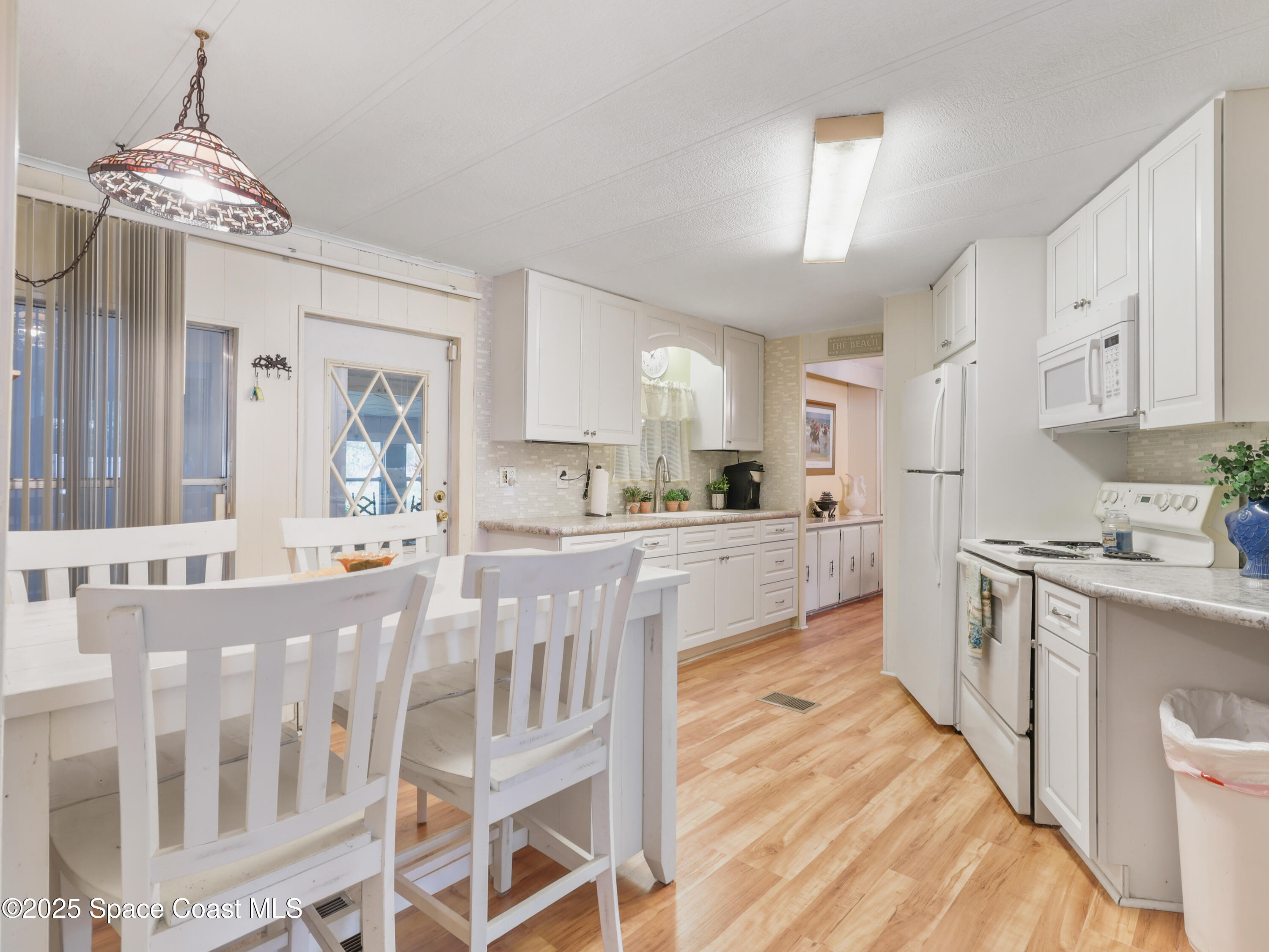 585 Canaveral Groves Boulevard Cocoa, FL 32926 - Photo 9 of 49 a large kitchen with kitchen island a large counter space a sink stainless steel appliances and cabinets
