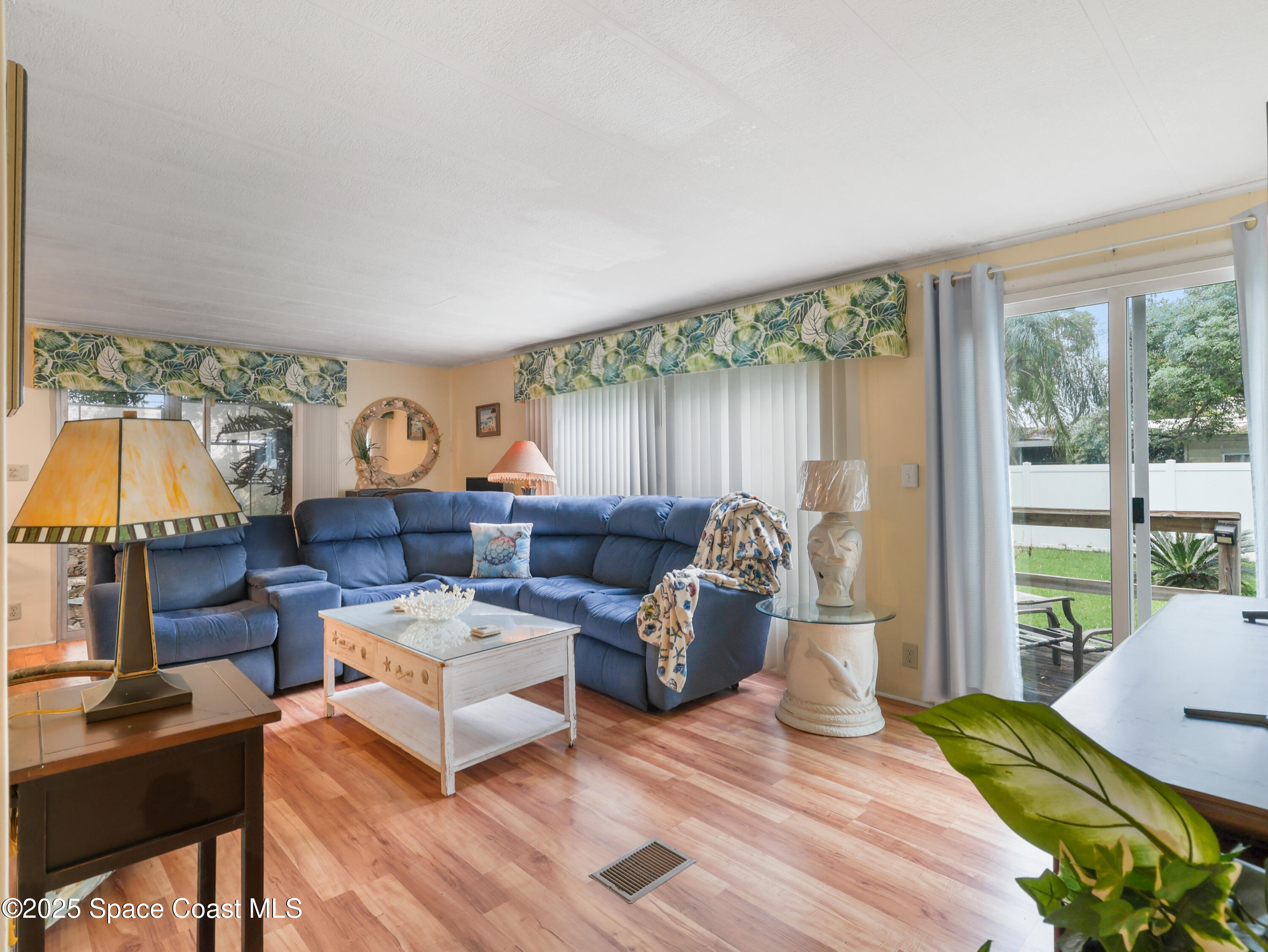 585 Canaveral Groves Boulevard Cocoa, FL 32926 - Photo 10 of 49 a living room with furniture and a large window