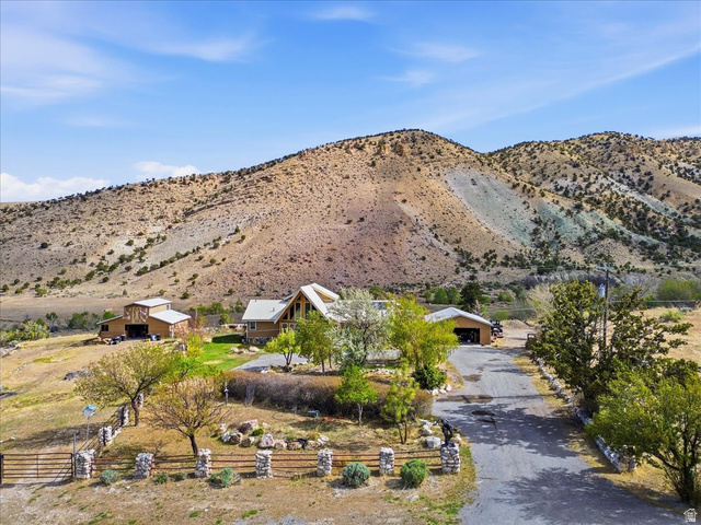 811 East Canyon Road Mayfield, UT 84643 - Photo 43 of 57 Spacious property featuring a main residence with a prominent A-frame roof and large windows, a detached garage, and an additional outbuilding