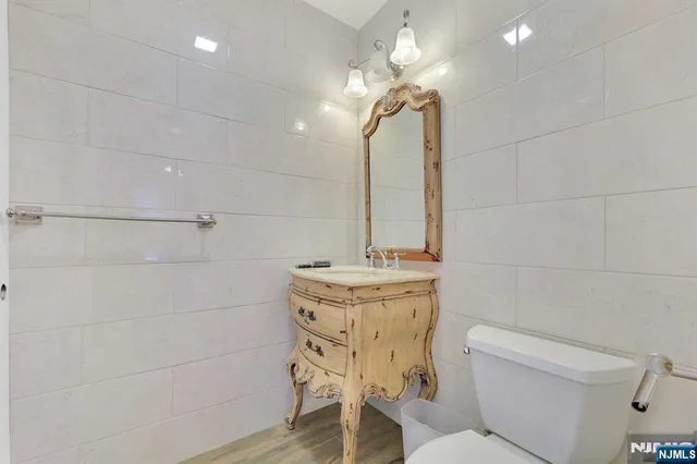 a bathroom with a sink a toilet and mirror