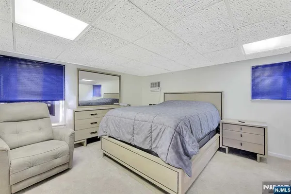 a spacious bedroom with a bed and a couch