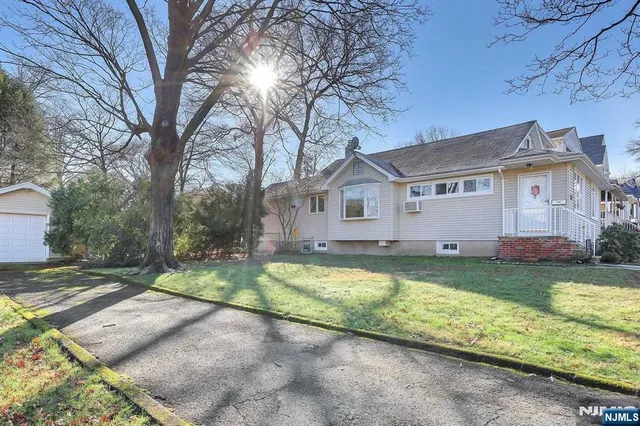 a view of a house with pool and a yard