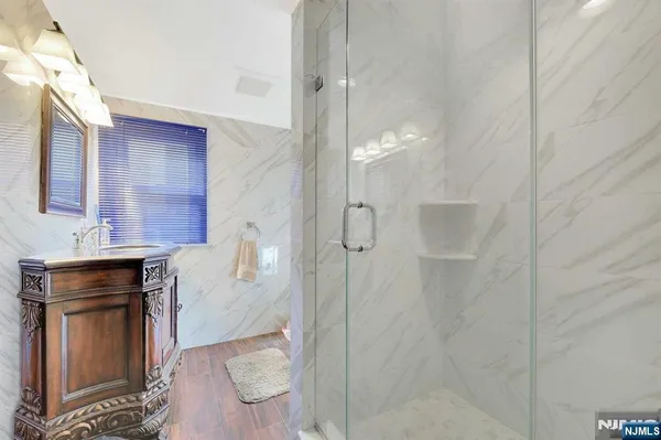 a bathroom with a shower and a sink