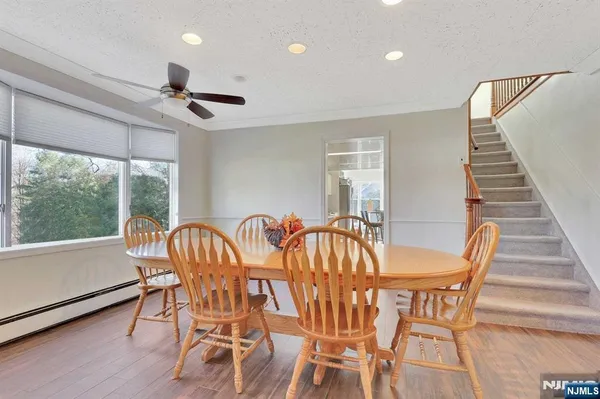 a view of a dining room with furniture window and wooden floor