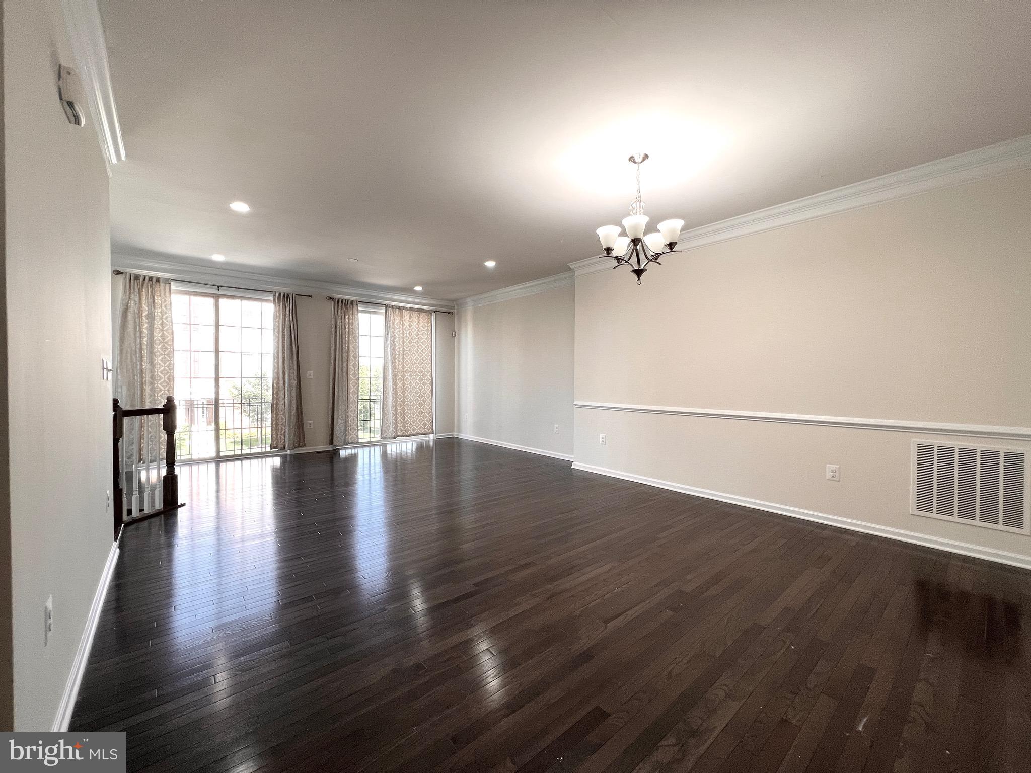 23480 Logans Ridge Terrace Ashburn, VA 20148 - Photo 12 of 66 an empty room with wooden floor and windows