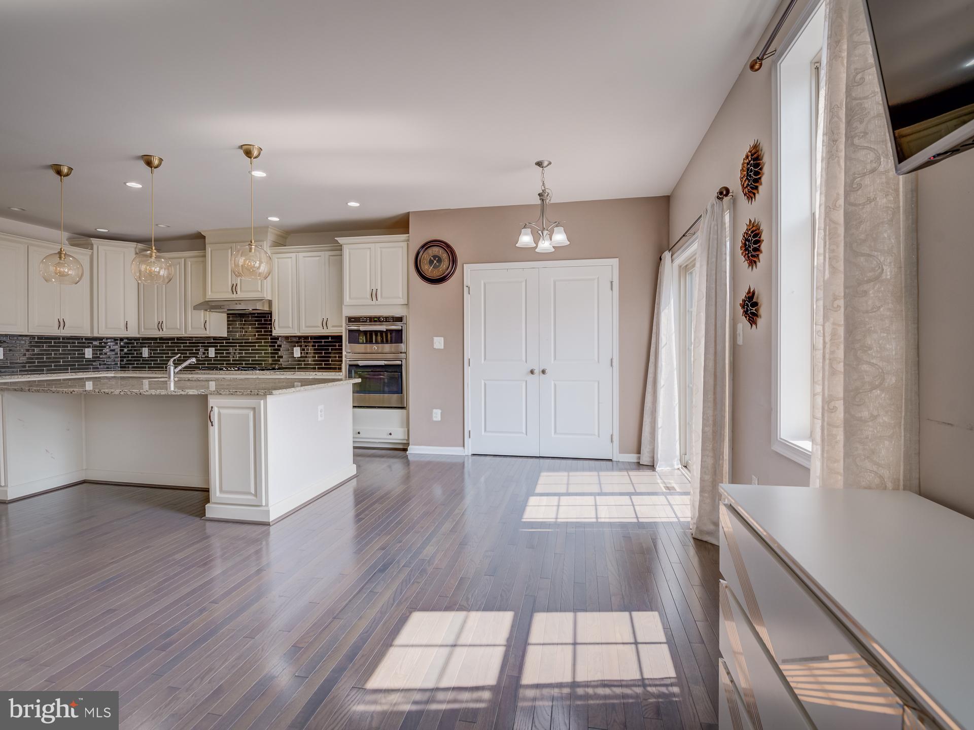 23480 Logans Ridge Terrace Ashburn, VA 20148 - Photo 13 of 66 a kitchen with stainless steel appliances granite countertop a stove a sink and a refrigerator