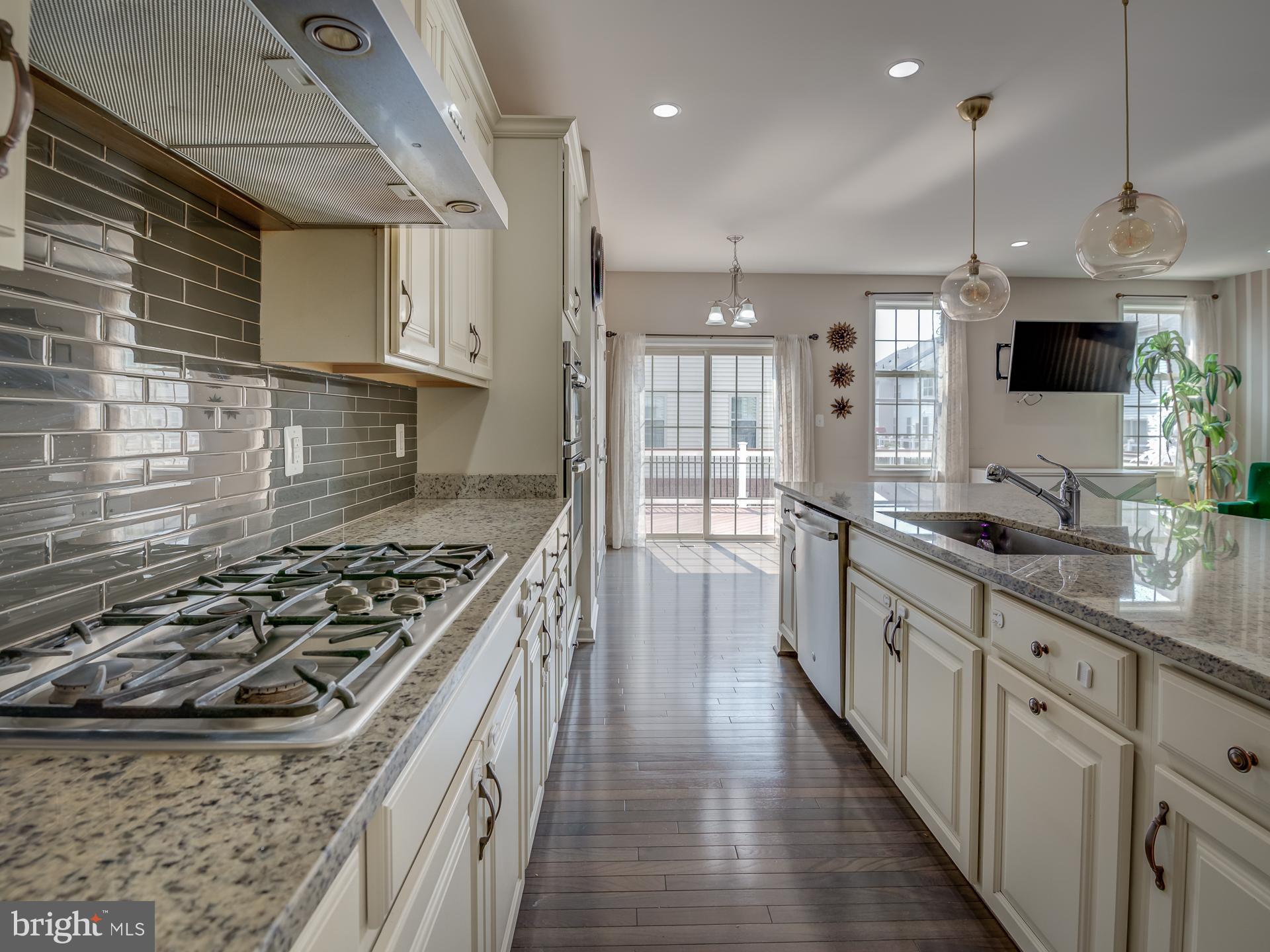 23480 Logans Ridge Terrace Ashburn, VA 20148 - Photo 15 of 66 a kitchen with stainless steel appliances granite countertop a stove a sink and a refrigerator
