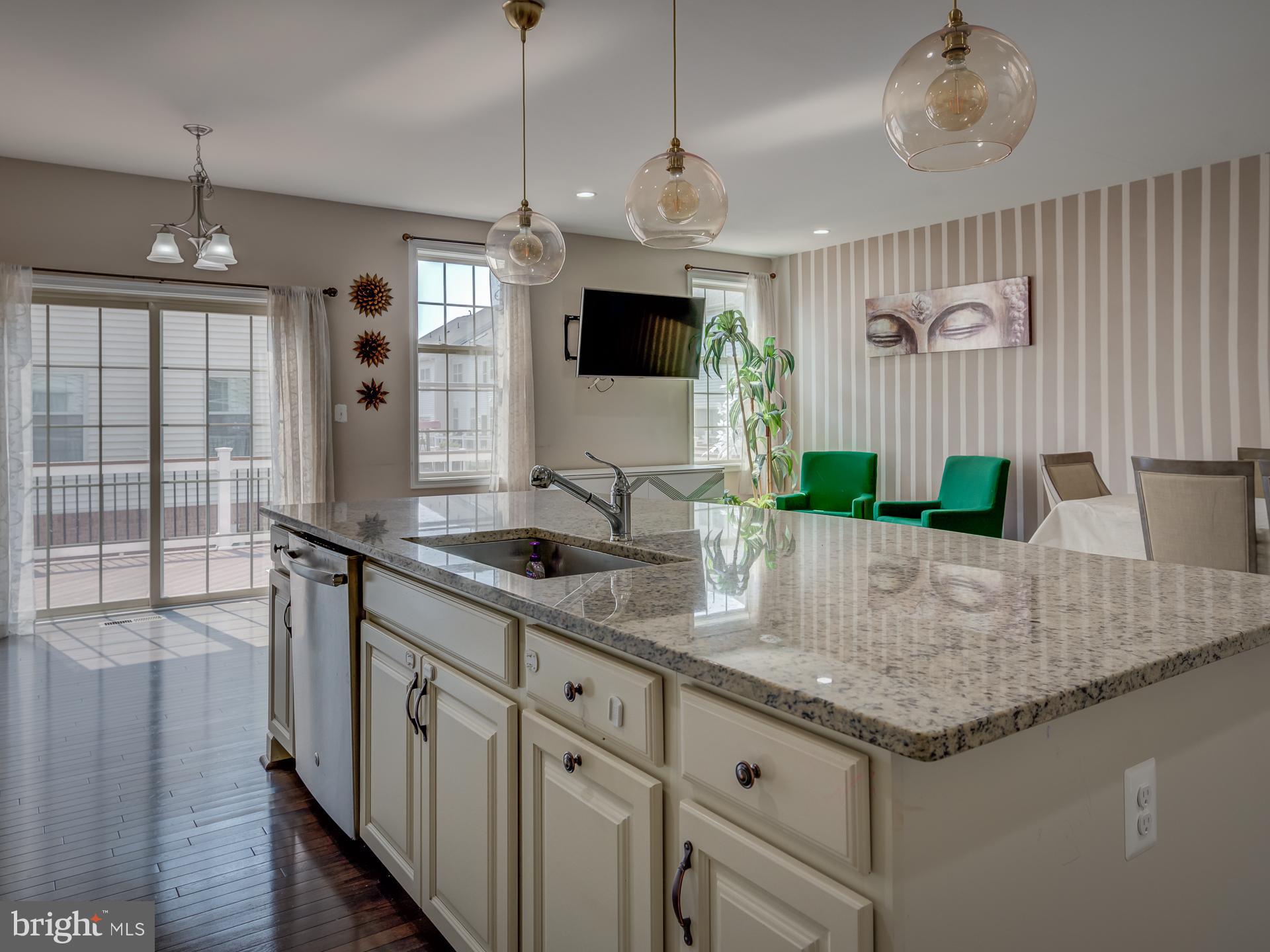 23480 Logans Ridge Terrace Ashburn, VA 20148 - Photo 16 of 66 a kitchen with granite countertop a sink stainless steel appliances and a chandelier