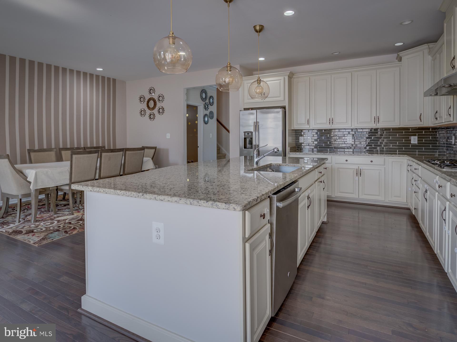 23480 Logans Ridge Terrace Ashburn, VA 20148 - Photo 17 of 66 a kitchen with stainless steel appliances granite countertop a sink stove and cabinets