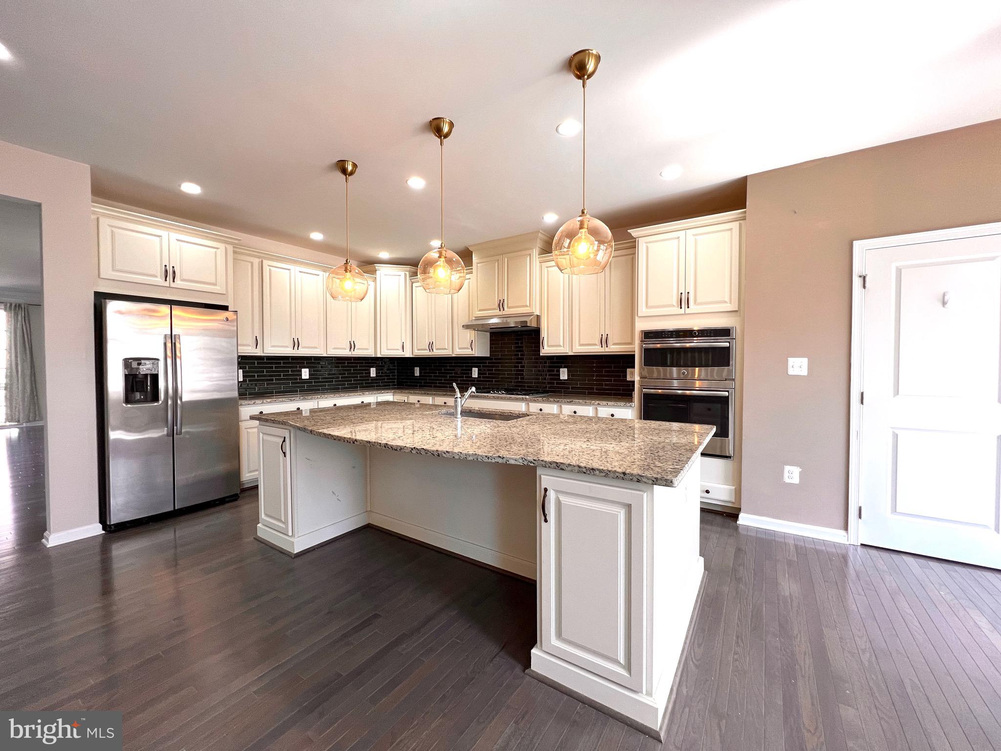 23480 Logans Ridge Terrace Ashburn, VA 20148 - Photo 24 of 66 a large kitchen with lots of counter space a sink appliances and cabinets