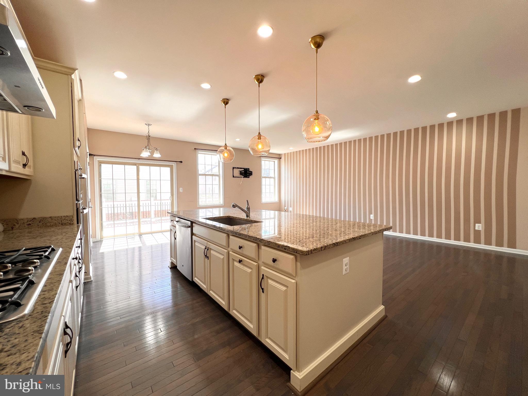23480 Logans Ridge Terrace Ashburn, VA 20148 - Photo 27 of 66 a kitchen with stainless steel appliances granite countertop a stove a sink a refrigerator and a wooden floor