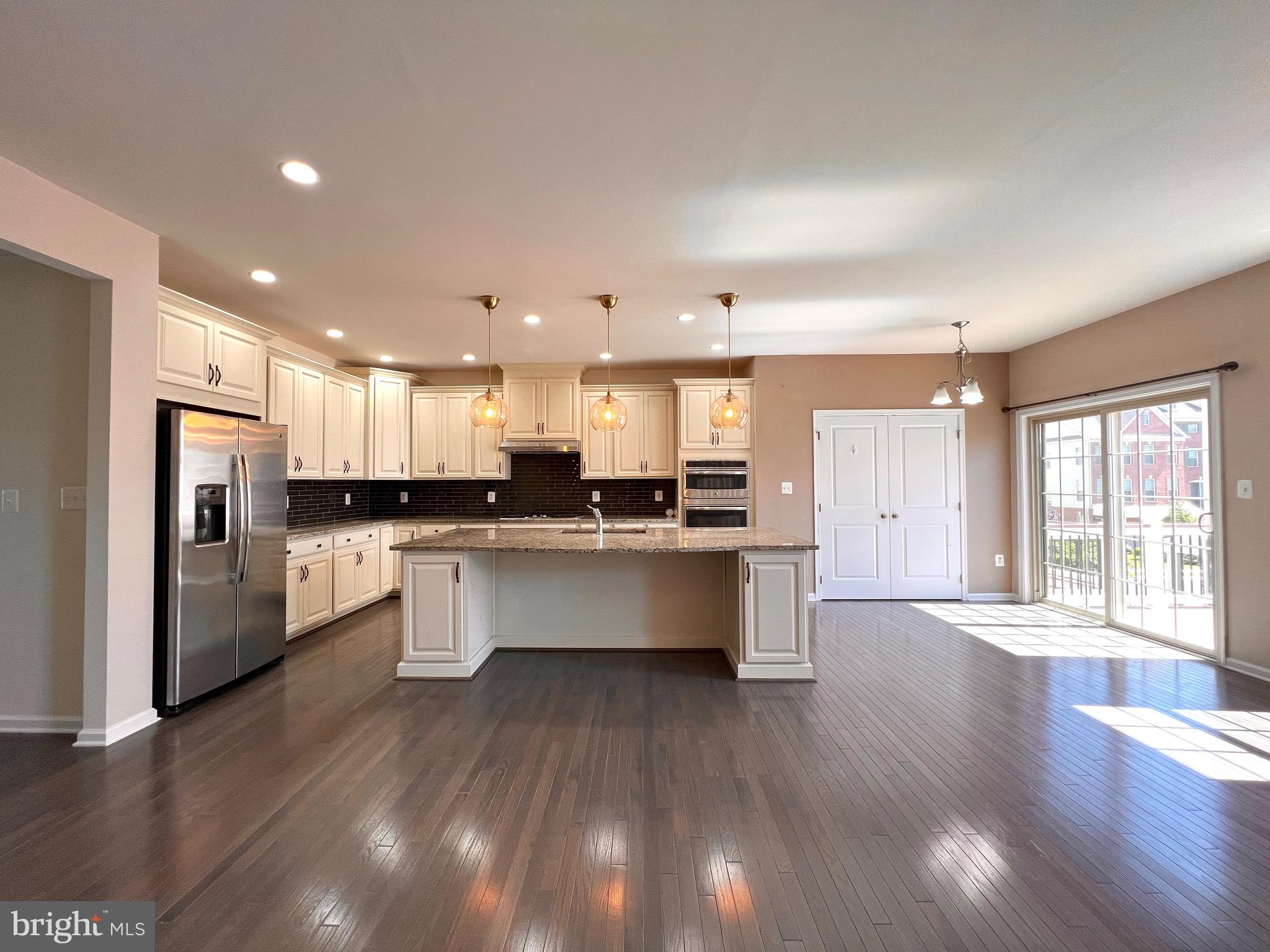 23480 Logans Ridge Terrace Ashburn, VA 20148 - Photo 29 of 66 a large kitchen with stainless steel appliances kitchen island a large counter top and a refrigerator
