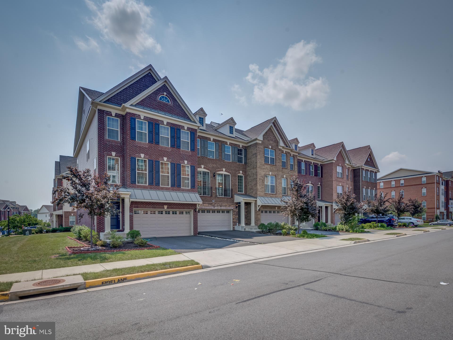 23480 Logans Ridge Terrace Ashburn, VA 20148 - Photo 3 of 66 a front view of a building with a garden and statue