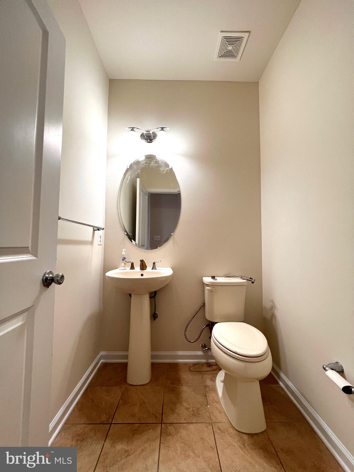 23480 Logans Ridge Terrace Ashburn, VA 20148 - Photo 31 of 66 a bathroom with a toilet sink and mirror