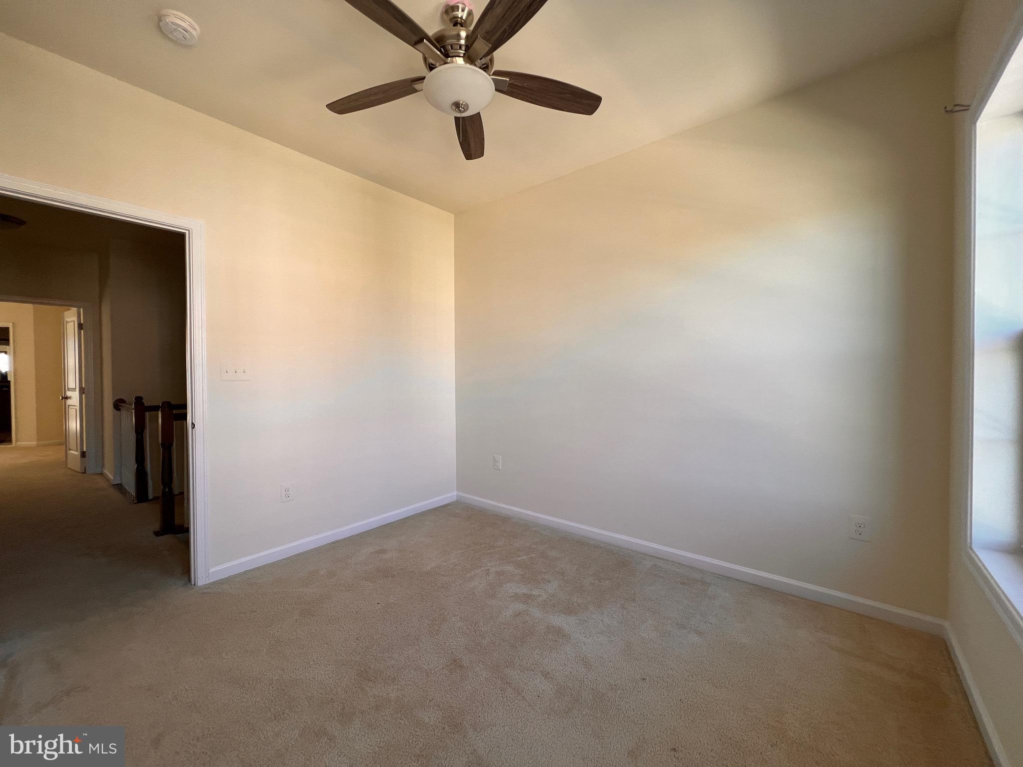 23480 Logans Ridge Terrace Ashburn, VA 20148 - Photo 38 of 66 an empty room with a ceiling fan and carpet