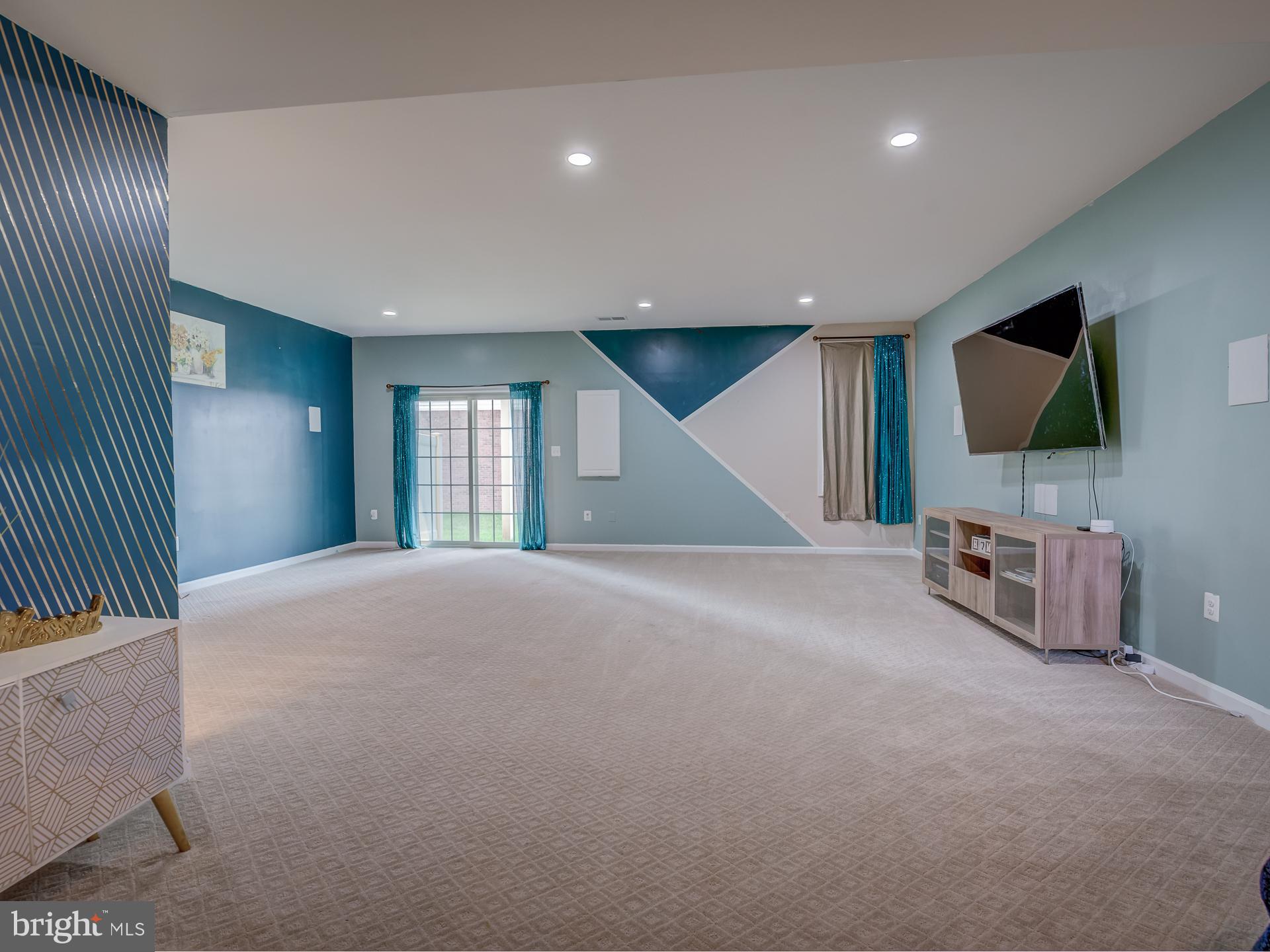 23480 Logans Ridge Terrace Ashburn, VA 20148 - Photo 57 of 66 a view of a livingroom with furniture and a flat screen tv