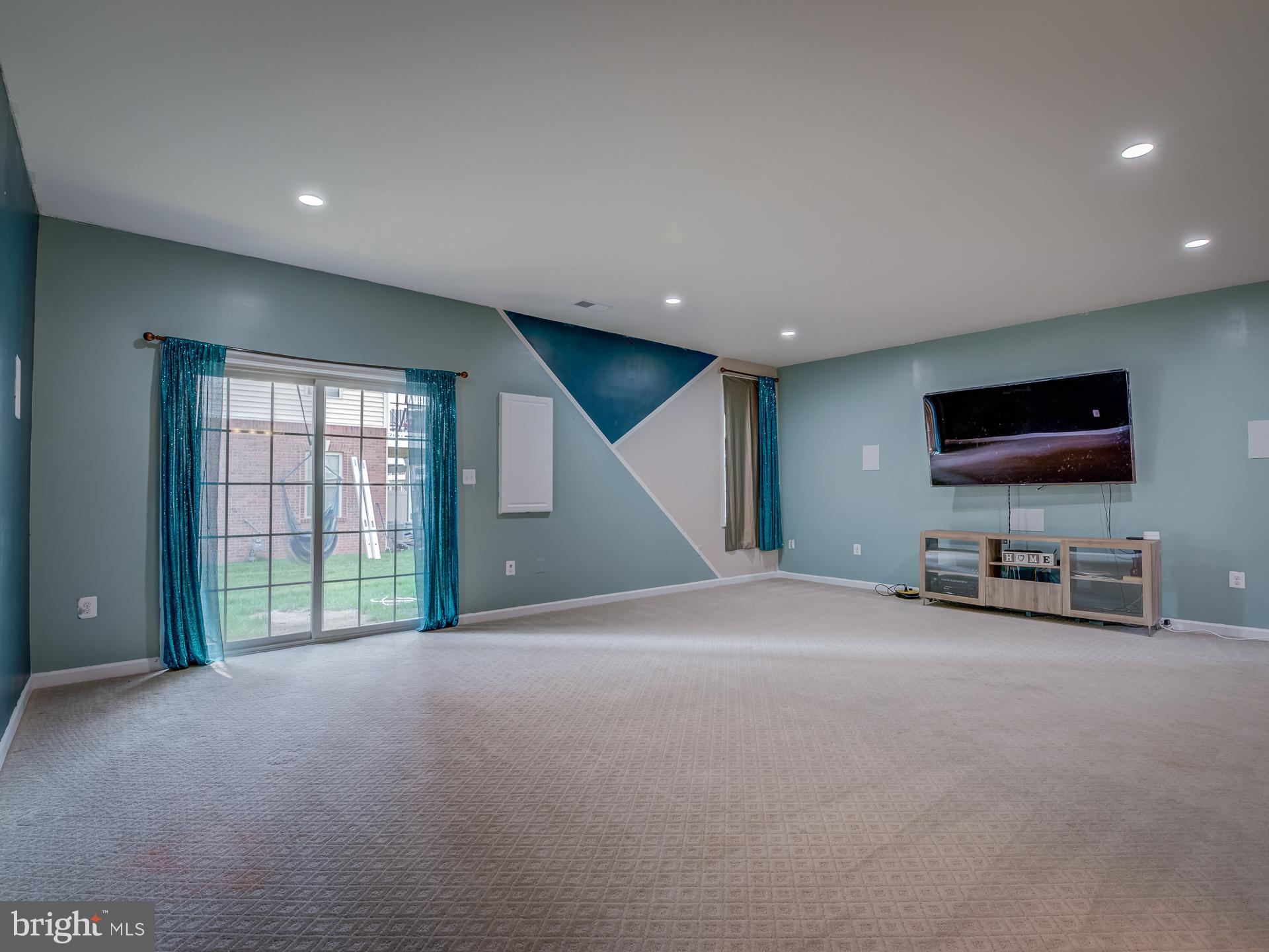 23480 Logans Ridge Terrace Ashburn, VA 20148 - Photo 58 of 66 a view of a livingroom with a flat screen tv and windows