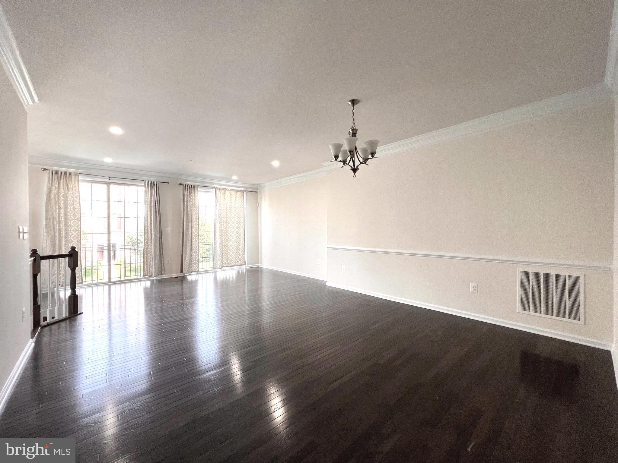23480 Logans Ridge Terrace Ashburn, VA 20148 - Photo 9 of 66 a view of an empty room with wooden floor and a window