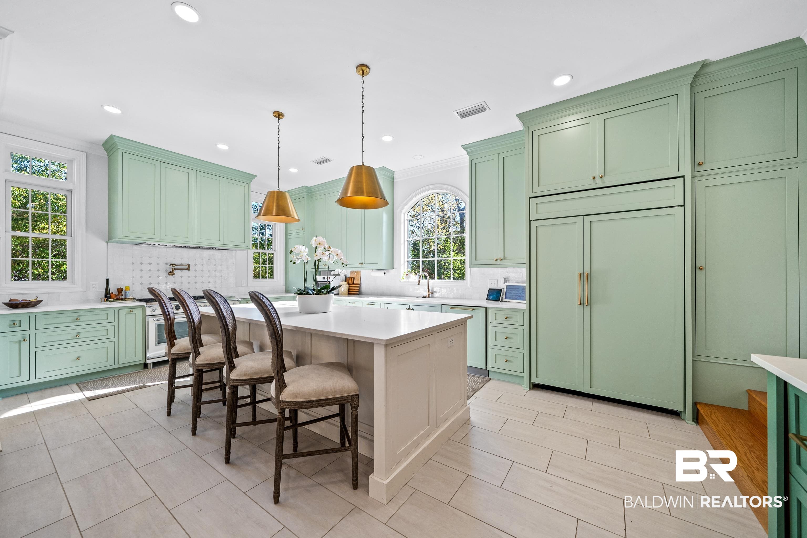 141 Myrtlewood Lane Mobile, AL 36608 - Photo 7 of 44 Kitchen featuring built in fridge, light countertops, visible vents, and green cabinetry