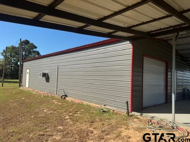 a garden with trees in the background