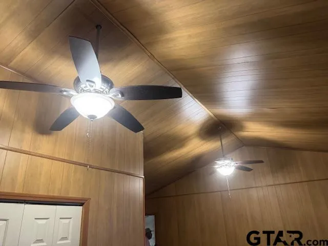 a view of a wooden bench next to a yard