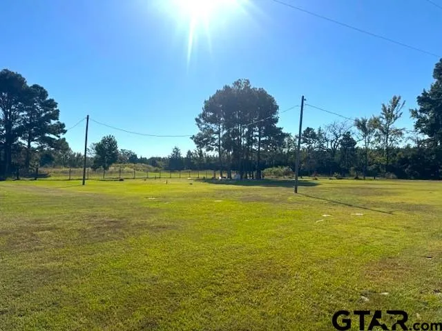a swimming pool with a big yard
