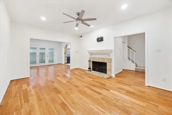 a view of empty room with wooden floor and fireplace