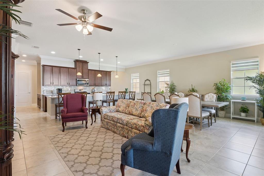2665 Meadowedge Loop St. Cloud, FL 34772 - Photo 25 of 53 a living room with furniture kitchen view and a chandelier