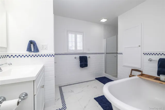 a bathroom with a bathtub and shower
