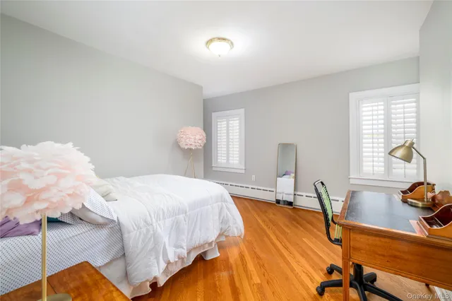 a living room with furniture a flat screen tv and a window
