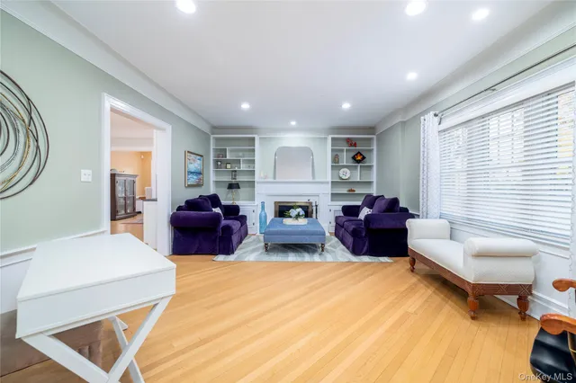 a dining room with stainless steel appliances granite countertop a dining table chairs and white walls
