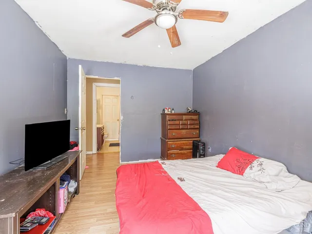 a bedroom with a bed and a chandelier