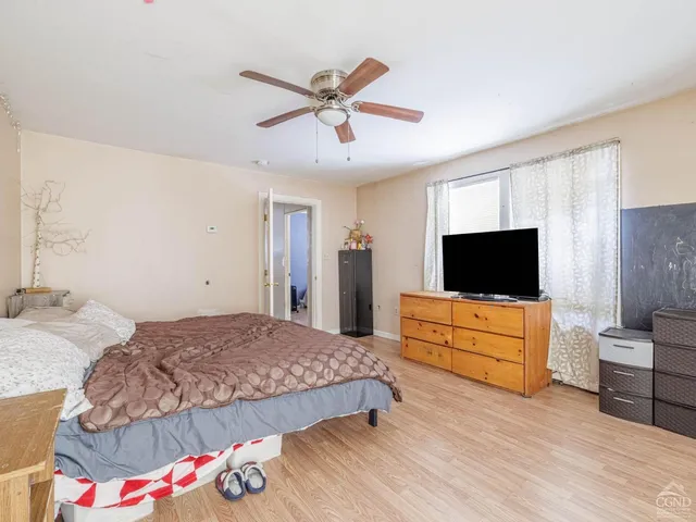 a bedroom with a bed and window