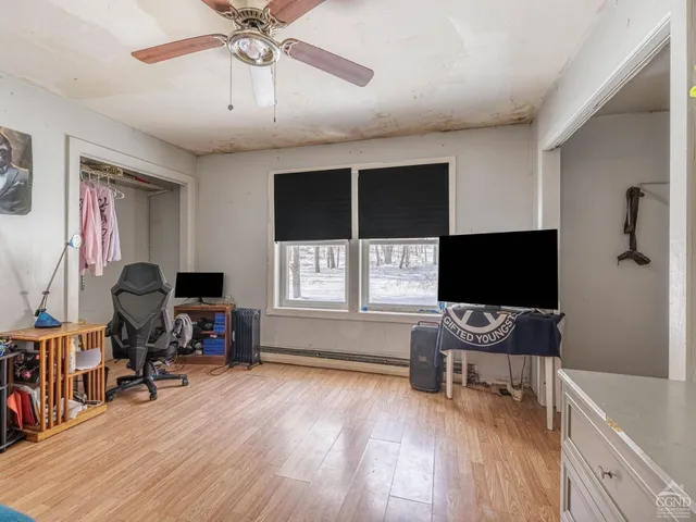 a bedroom with furniture and a window