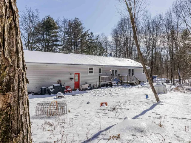 a view of a house with snow on the road