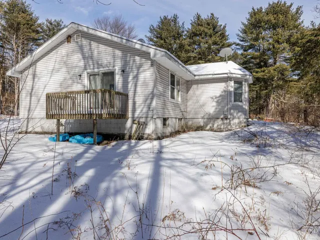 a view of a house with a wooden fence