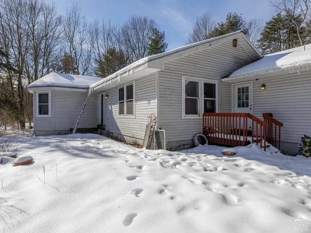 a view of a house with a yard and sitting area
