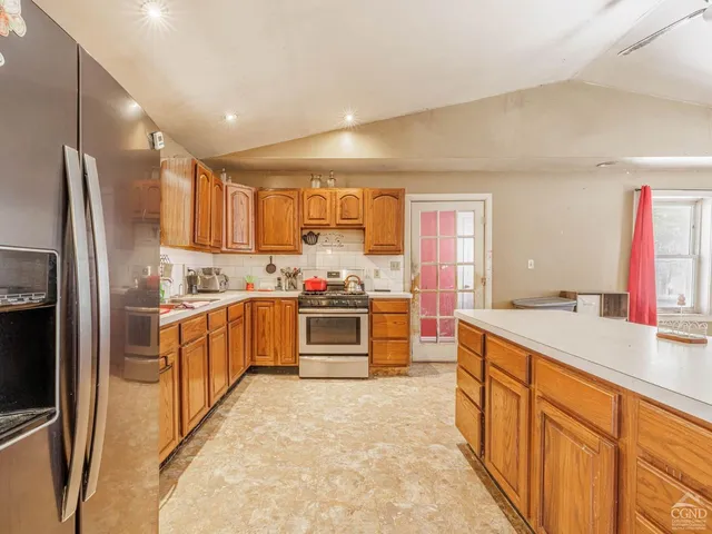 a living room with furniture and kitchen view