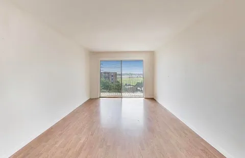 a view of an empty room and glass door
