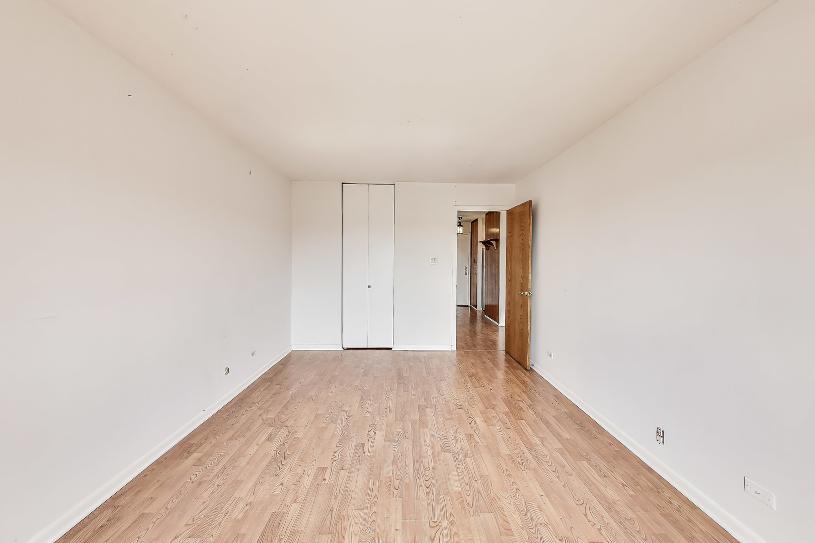 701 West Huntington Commons Road, Unit 418 Mount Prospect, IL 60056 - Photo 10 of 10 a view of an empty room with wooden floor