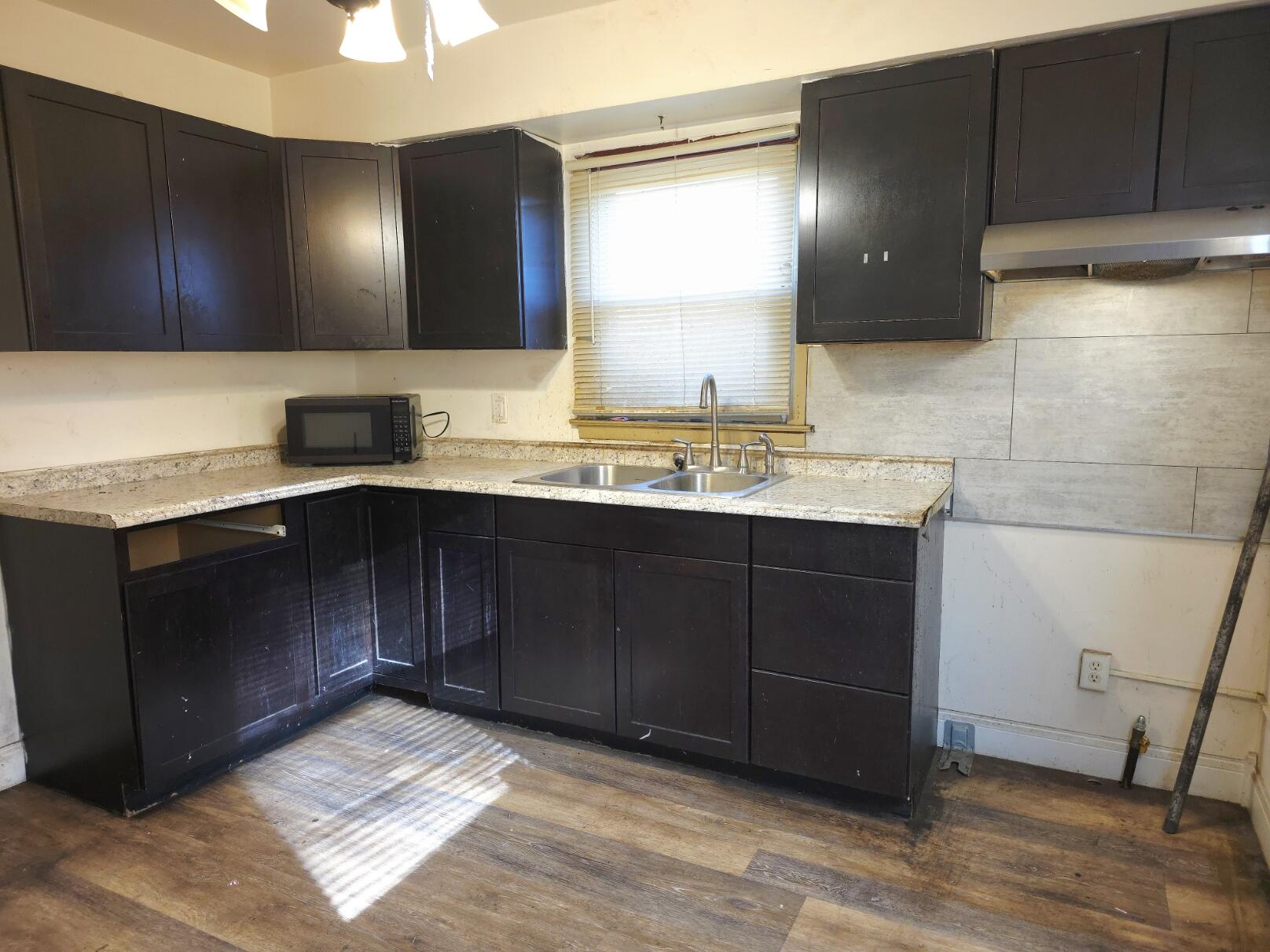 794 Porter Street Gary, IN 46406 - Photo 2 of 15 a kitchen with a sink and a mirror