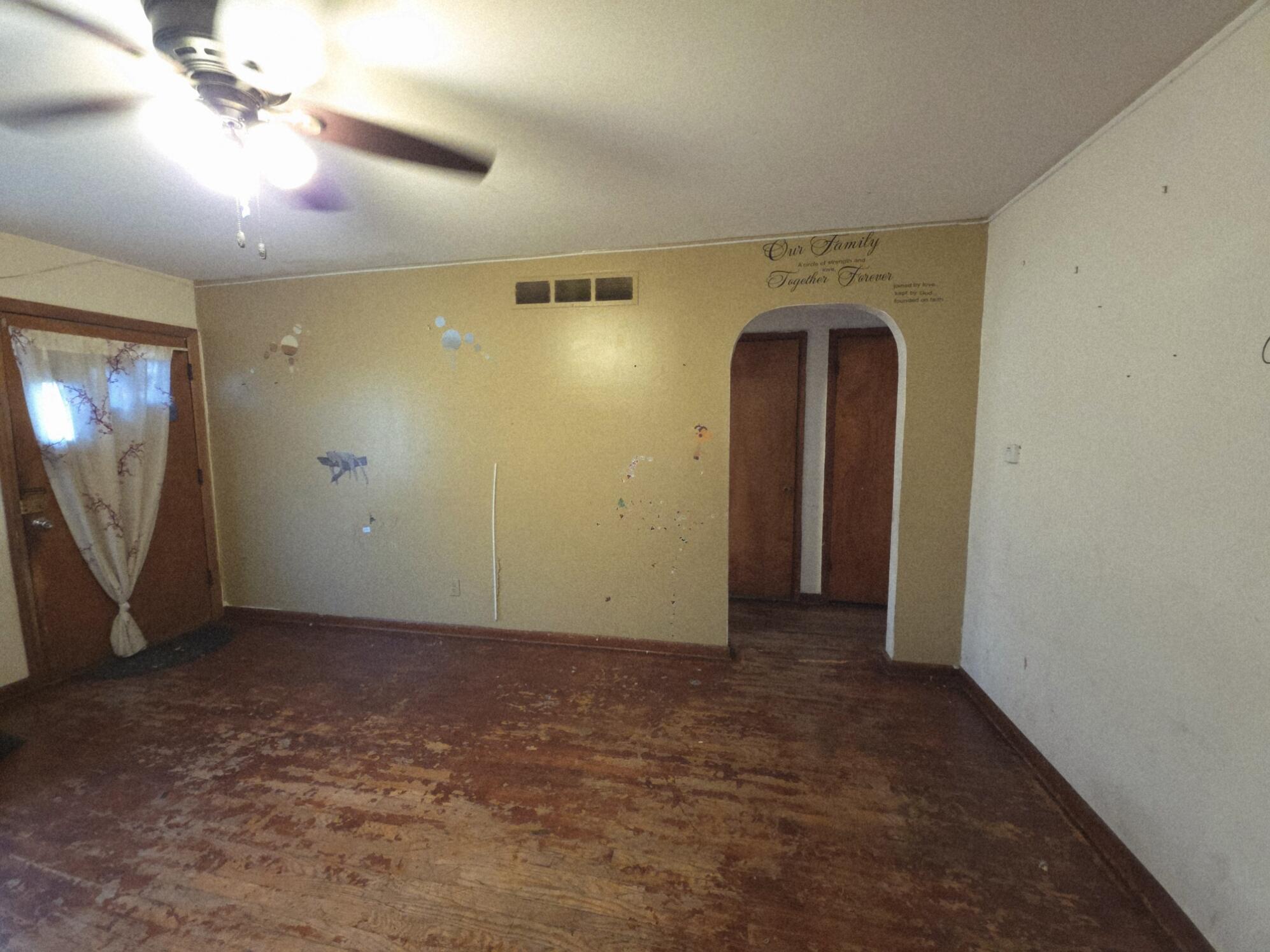 794 Porter Street Gary, IN 46406 - Photo 3 of 15 en empty room with windows and fan