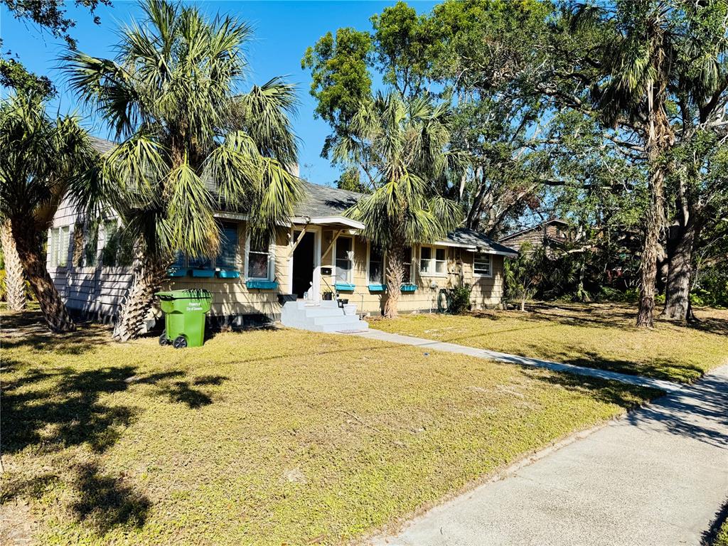 624 Goodrich Avenue Sarasota, FL 34236 - Photo 16 of 45 a view of a swimming pool with a lawn chairs under palm trees