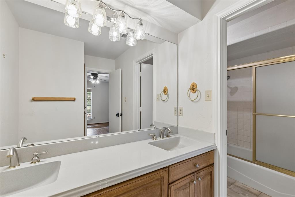 4 Eastshore Road Heath, TX 75032 - Photo 20 of 37 a bathroom with a sink a vanity and a mirror