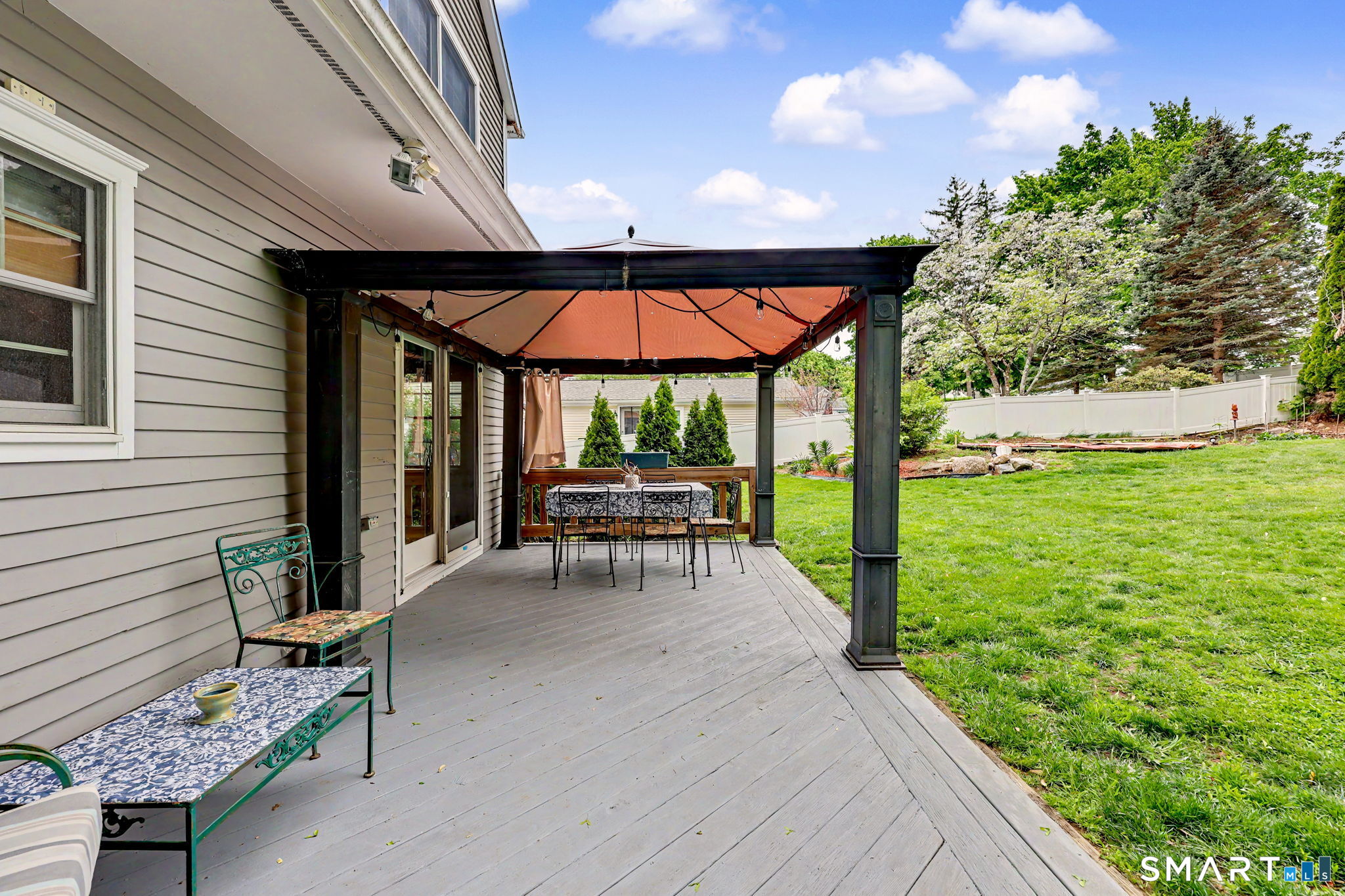 7 Merrill Road Trumbull, CT 06611 - Photo 38 of 40 a view of a patio with table and chairs potted plants with wooden floor