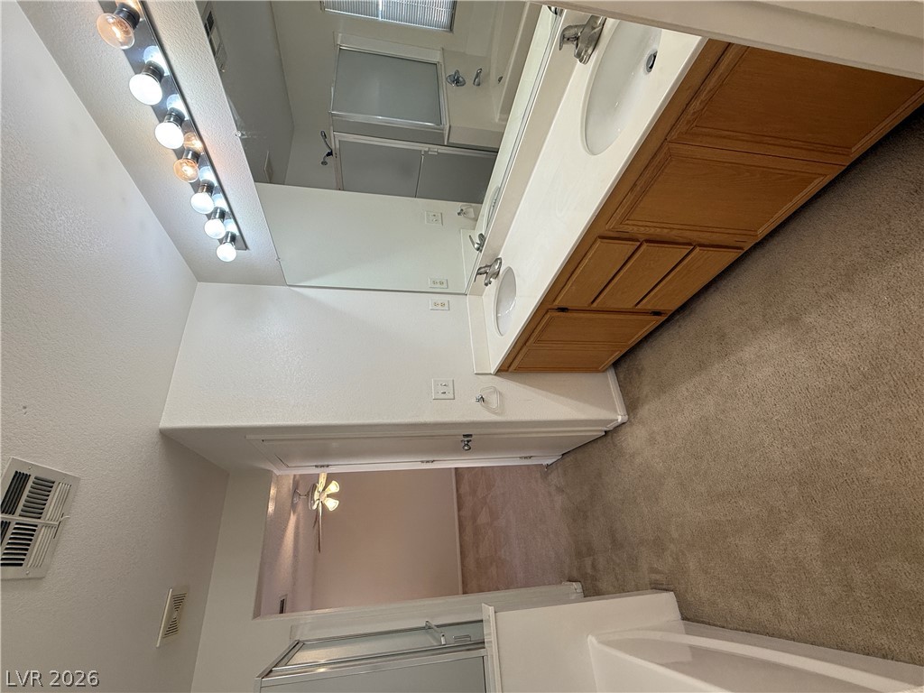 8108 Roundup Ridge Street Las Vegas, NV 89131 - Photo 17 of 21 Double vanity and a deep tub offer a comfortable and functional bath retreat.