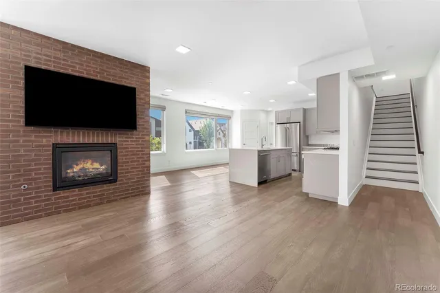 a view of a living room a kitchen and a fireplace